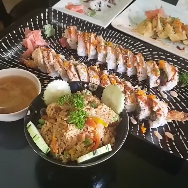 Small plates served beside tea and chopsticks.