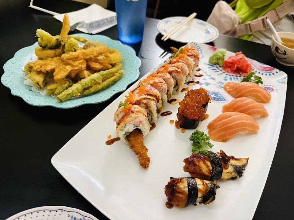 Small plates served beside tea and chopsticks.